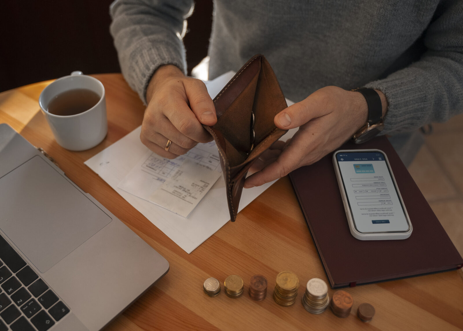 man opening his empty wallet